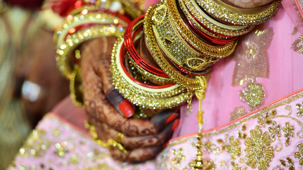 a celebration or special occasion where the person has adorned themselves beautifully. Henna designs and bangles are often associated with traditional ceremonies, weddings, and festive events. The intricate patterns and vibrant colors make this a captivating composition! 